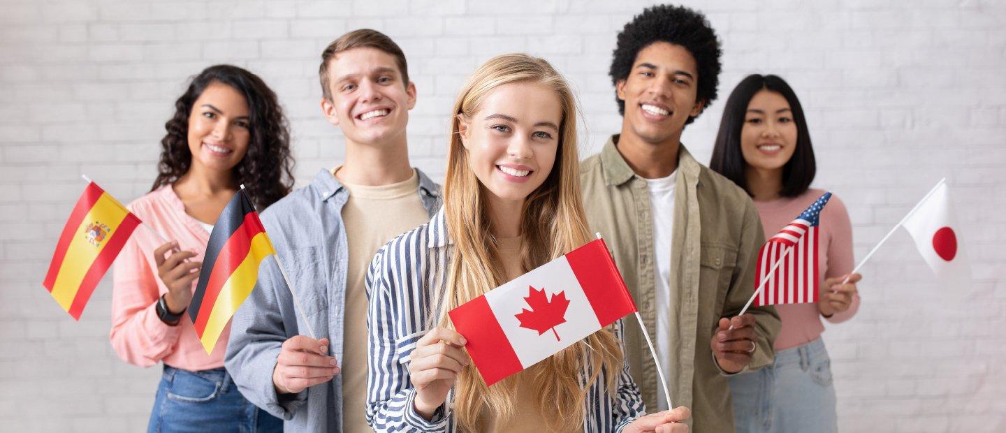 A group of students, each holding a flag from a different country.