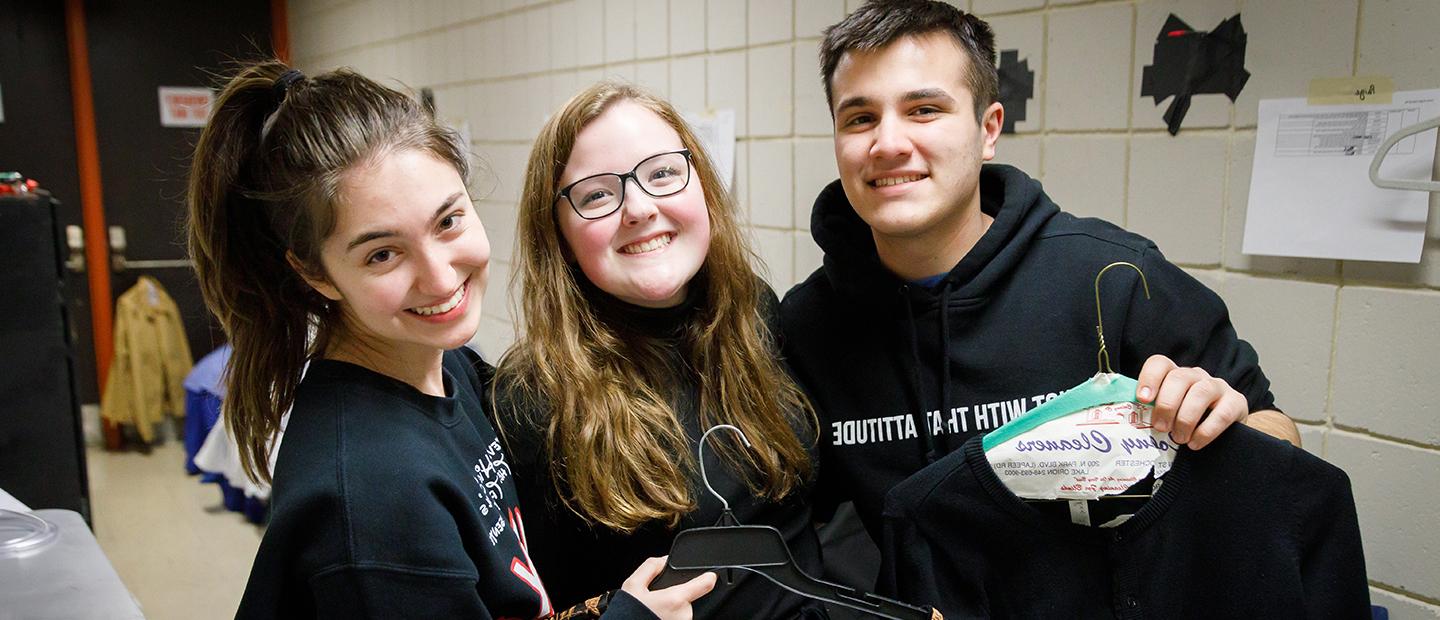 image of three young people backstage, smiling